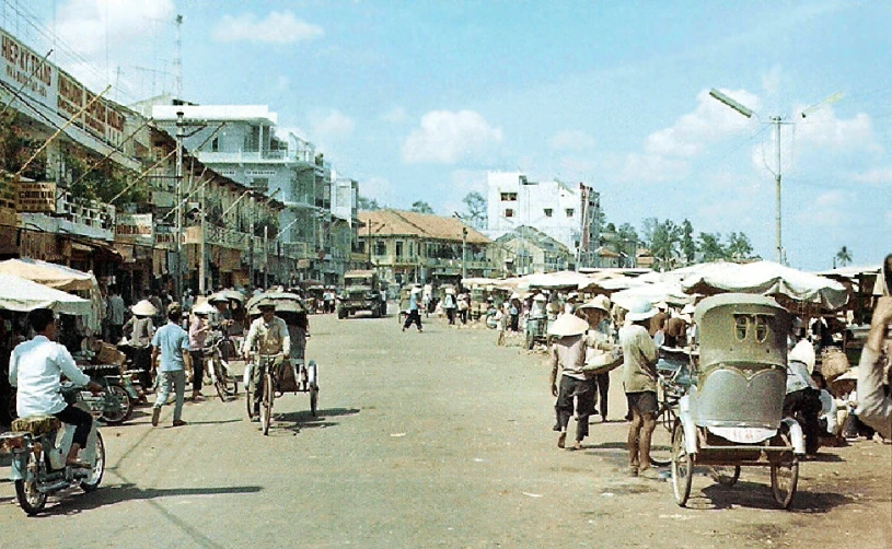 people walking on the side walk on bicycles and scooters