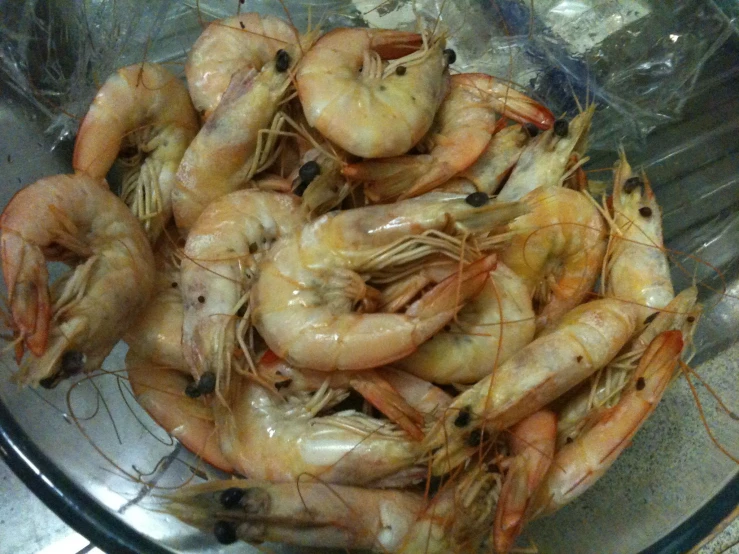 a large bowl of shrimp sitting on top of a table