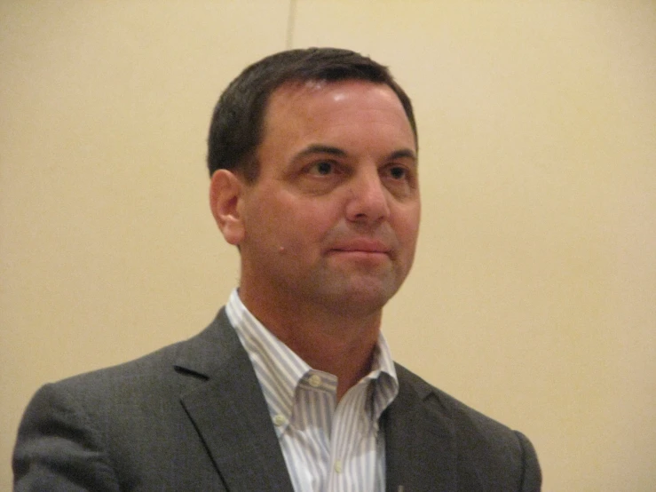 a man wearing a suit and white shirt