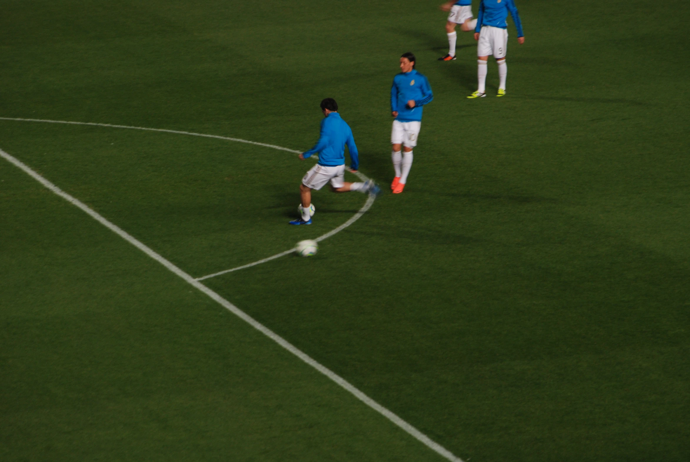 a group of soccer players stand on the grass