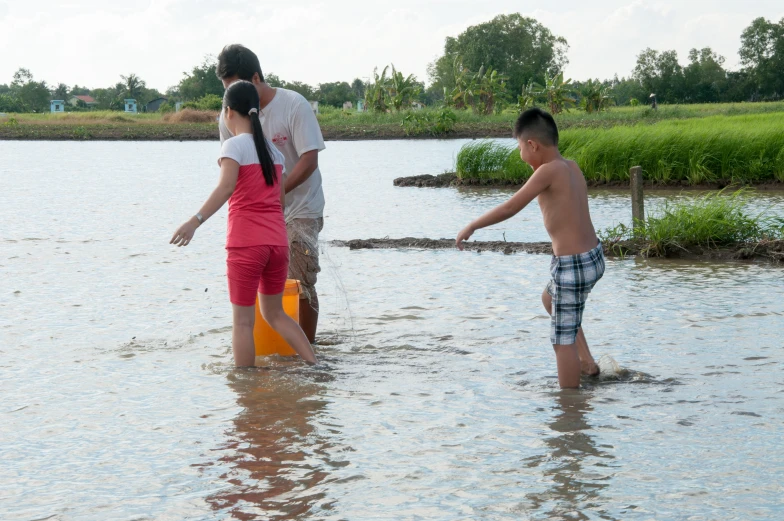 a group of people that are standing in the water