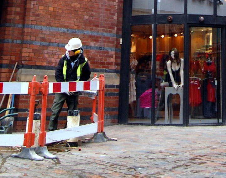 a man in a hard hat standing on a street