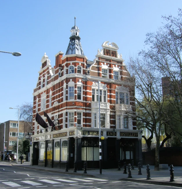 an old, historic style building sits along the road in this city