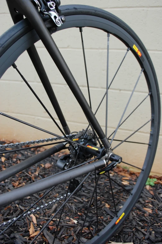 close up view of a bicycle's wheels in front of a building