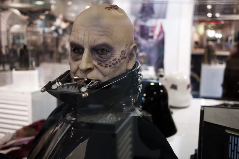 a display of a man dressed in black gear with skull and eye tattoos