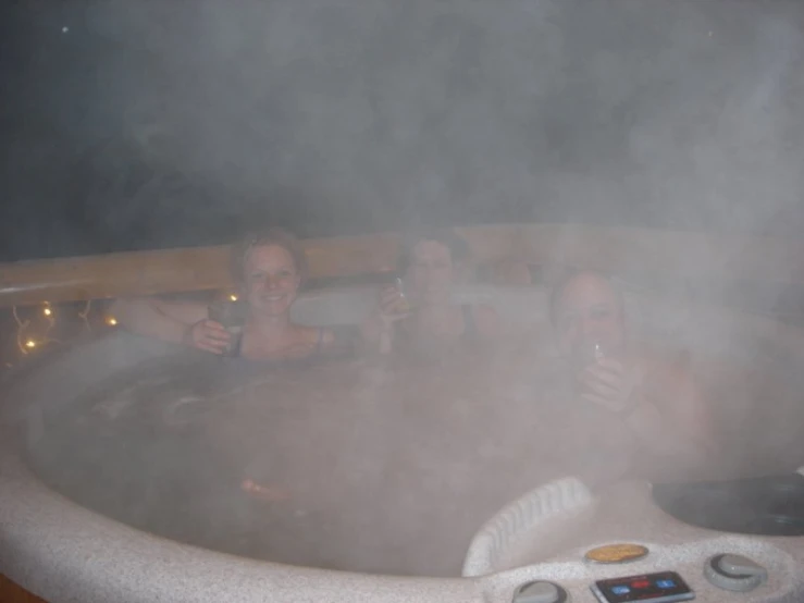 people in the sauna at the spa having beer and water