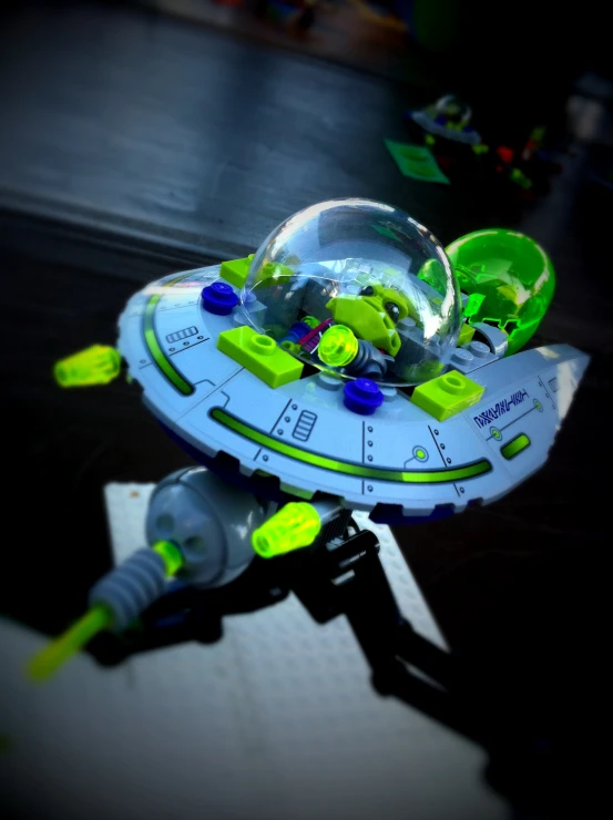 a small green space ship with light green gears and neons
