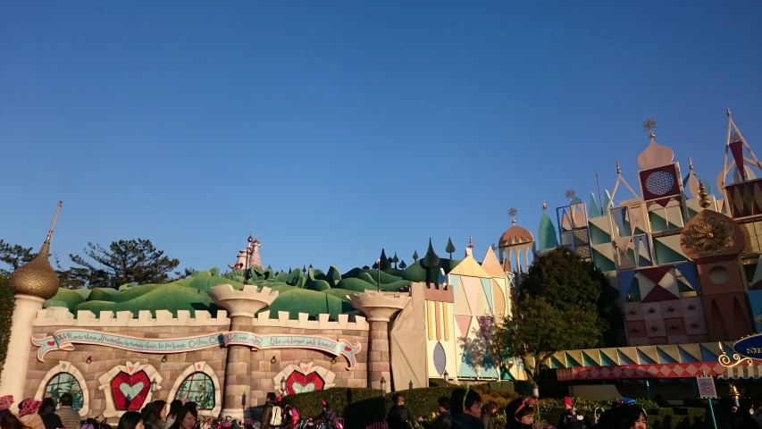 a crowd at disneyland world watching the ride