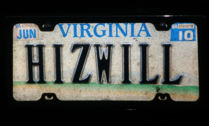 the license plate is written in blue and white