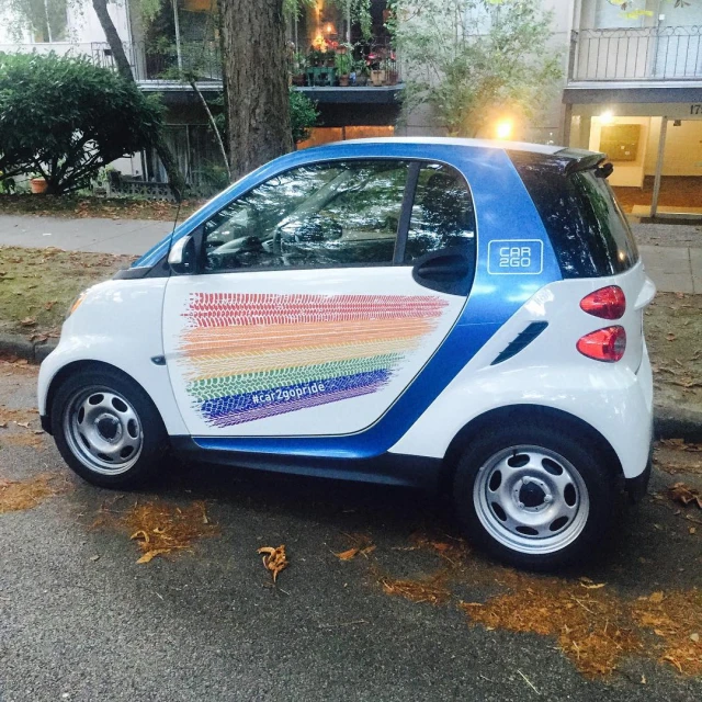 small smart car with different colors in street scene