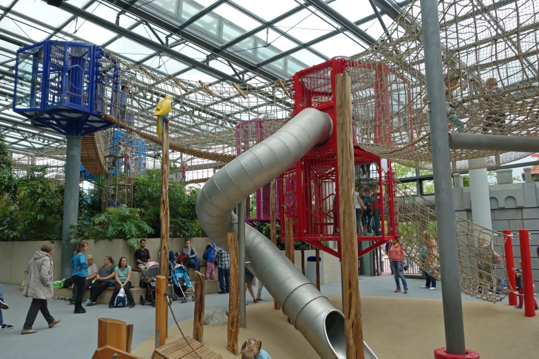 people walking in a garden with giant slide