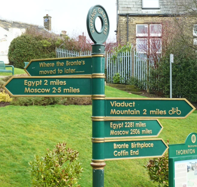 a collection of signs pointing to various locations