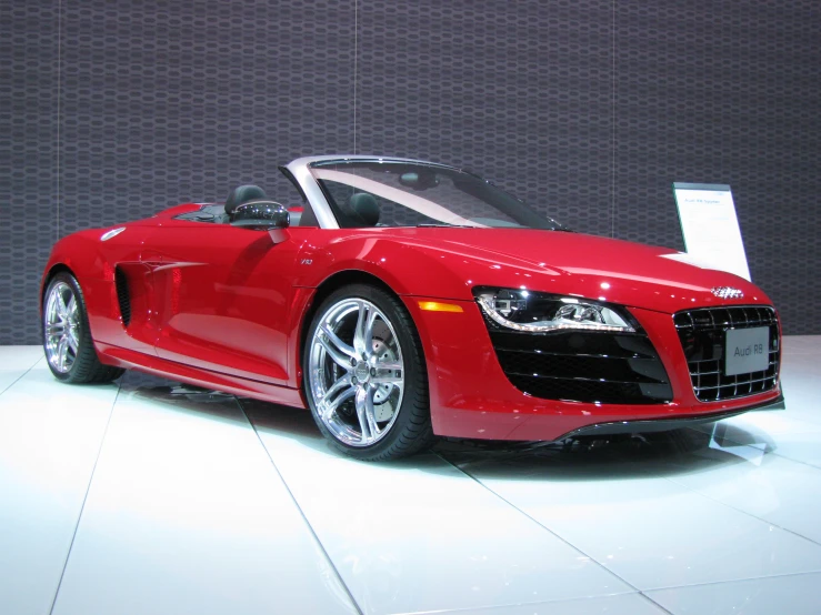 a red sports car is displayed at the dealers booth