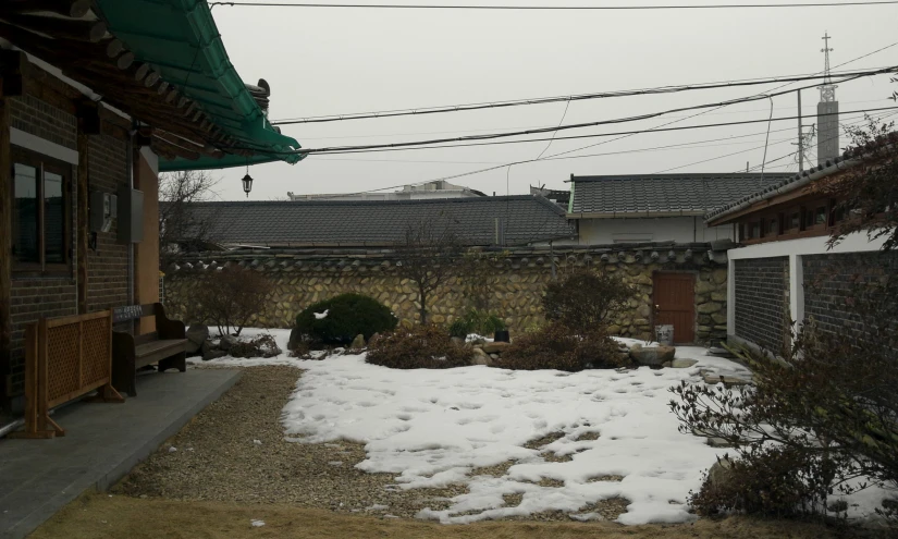 an asian village is shown through snow covered landscape