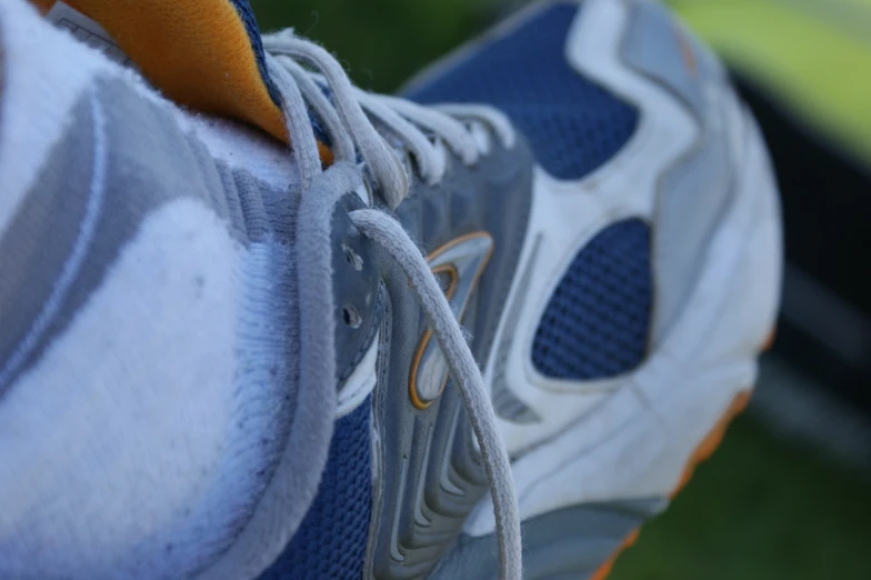 close up of a man's running shoe in blue and white