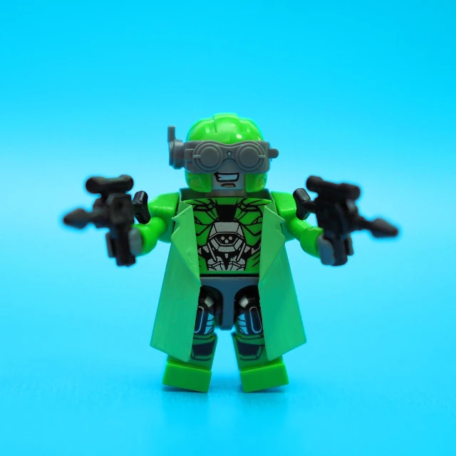 a toy action figure with green skin on a blue surface