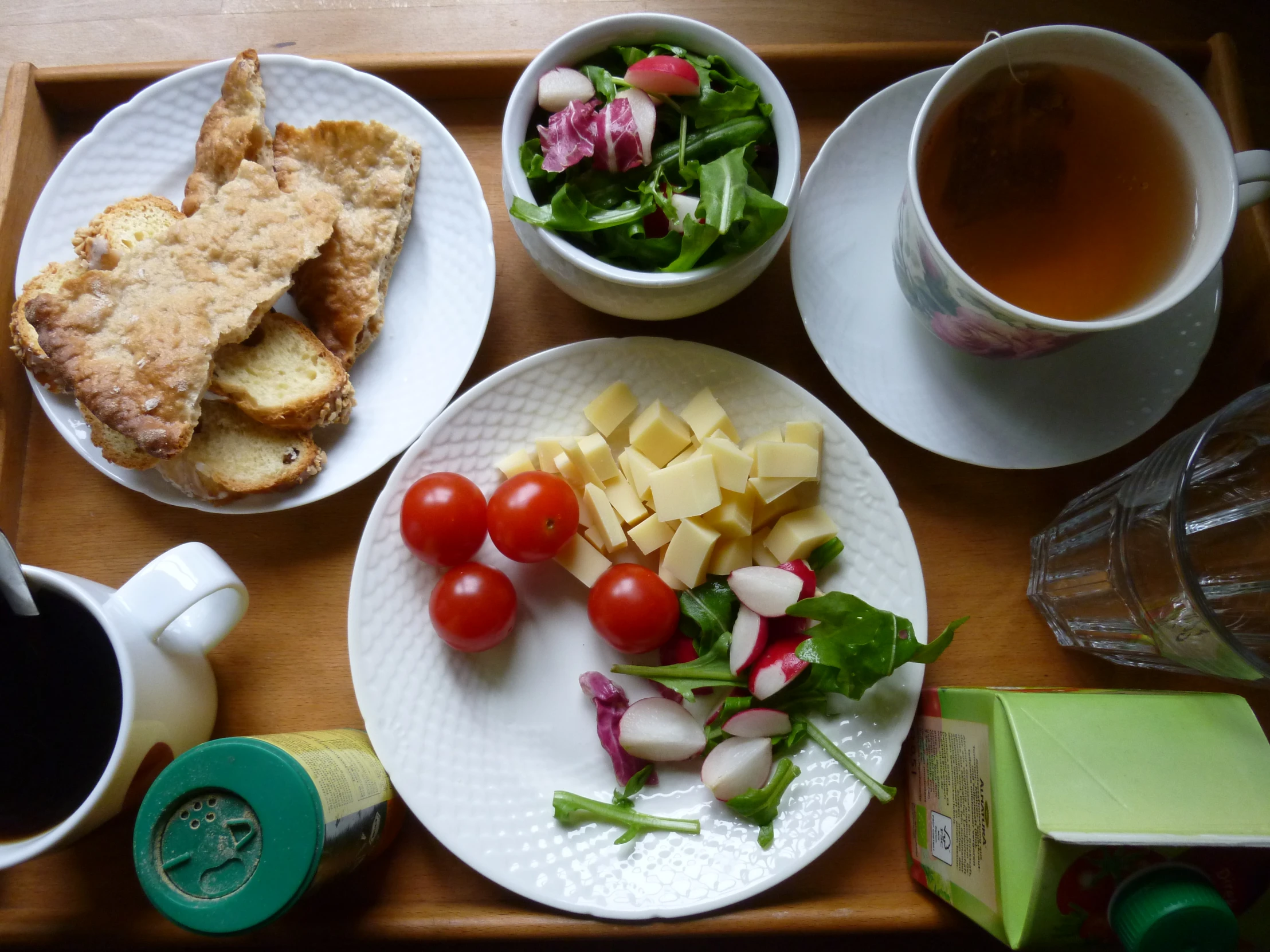 a meal of meat, tomatoes and bread and tea