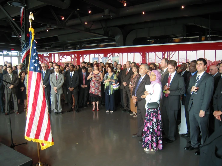 an event with a lot of people in a room and one person holding a flag