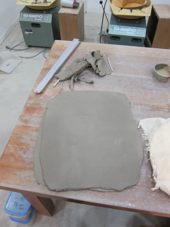 a wooden table with some gray cement on it