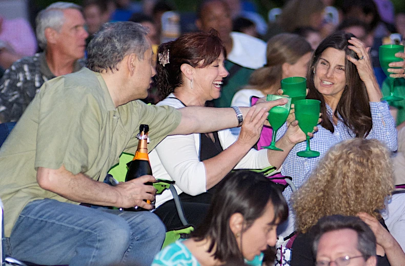 people in a large crowd drinking and having drinks