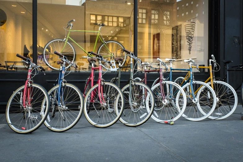 several different types of bicycles parked on a street