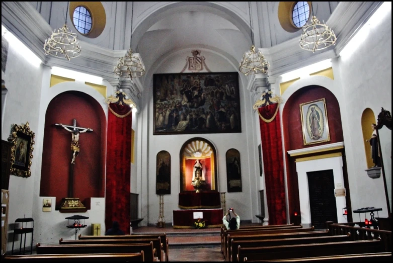 a large church with wooden pews and red curtains