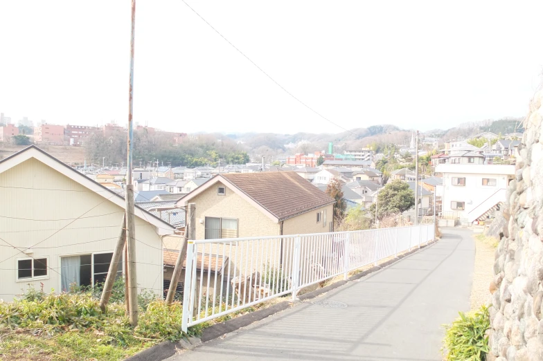 there are houses in the background with a fence on either side