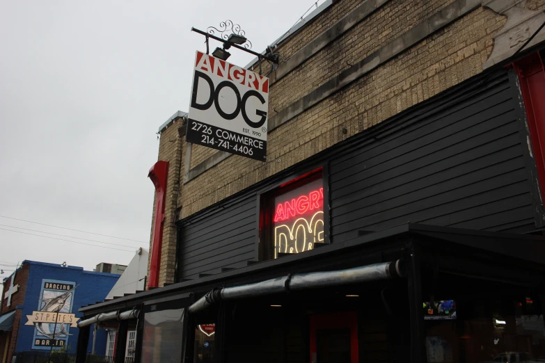 a brick building with a sign that says angry dog