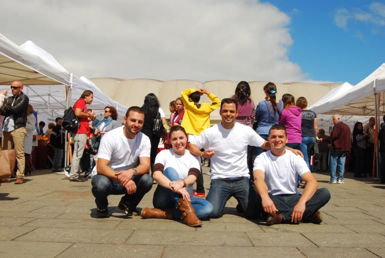 there are four people sitting down posing for a picture