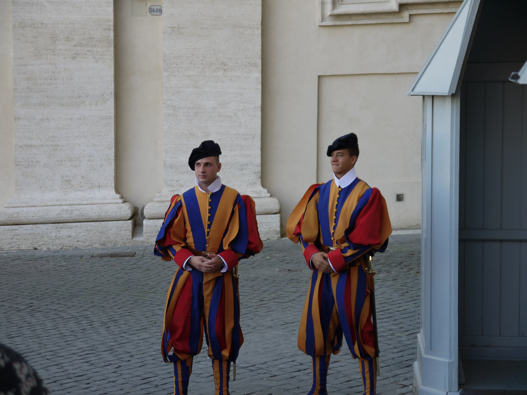 two men dressed in different colored outfits with swords