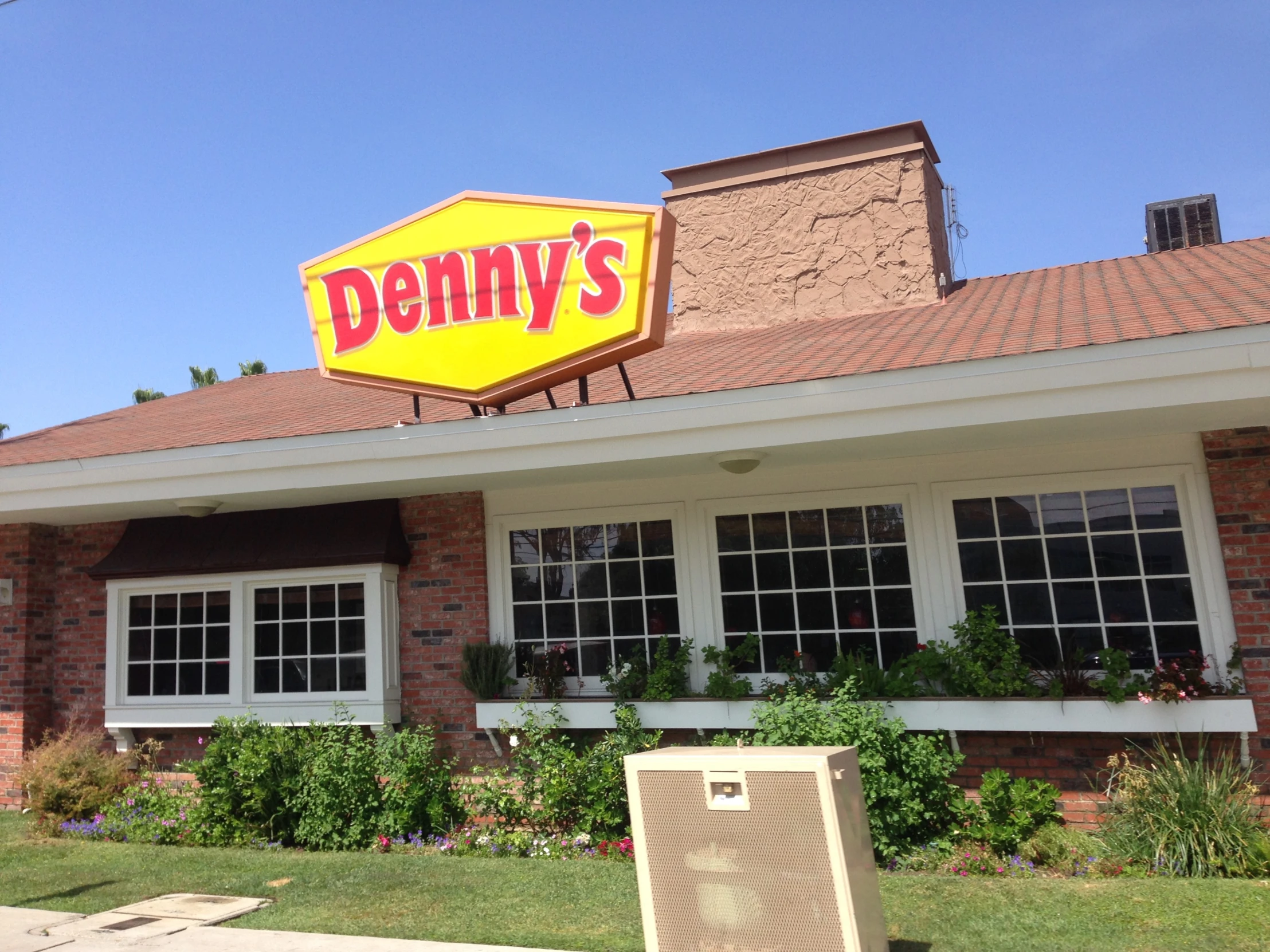 this is a large dennys sign in front of a house