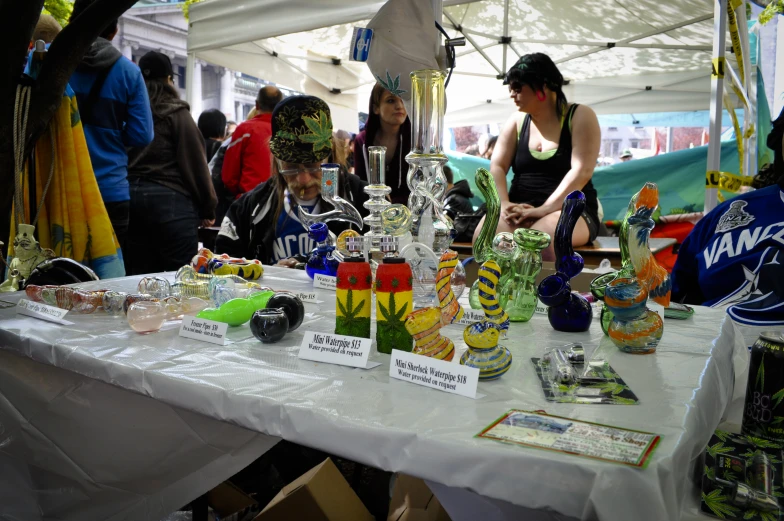 some people at a booth with many different kinds of items