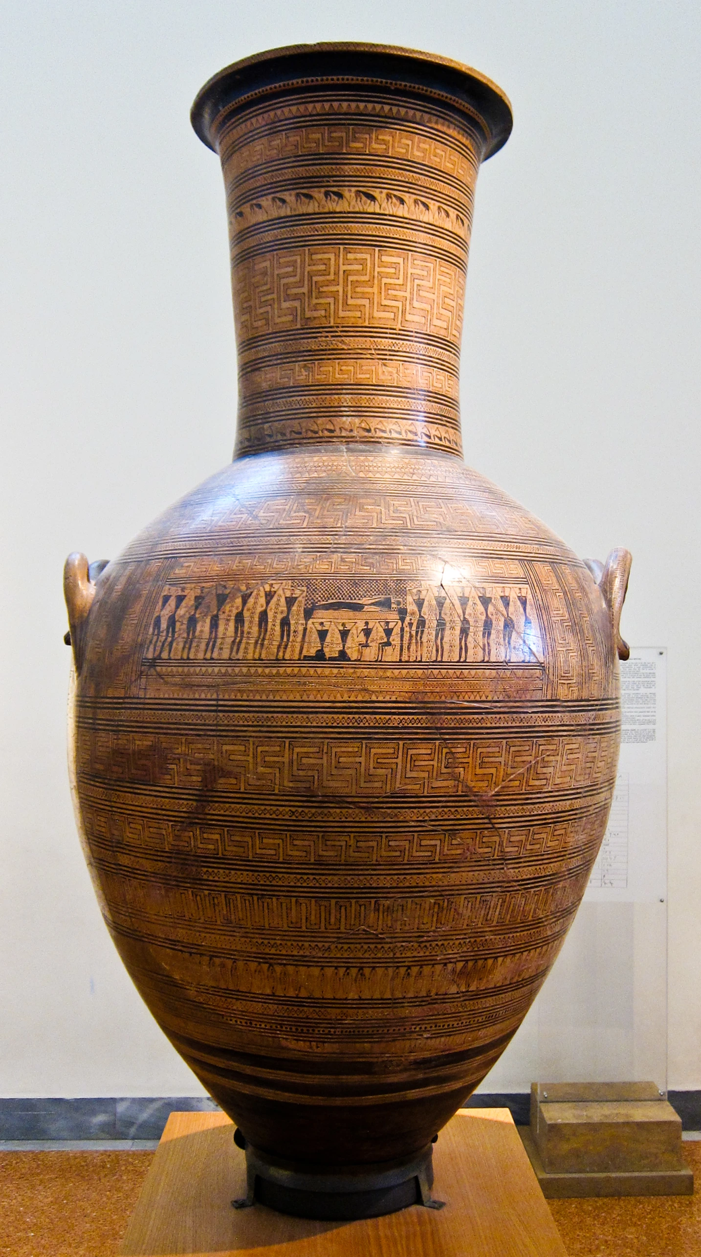 an antique greek vase with writing on it