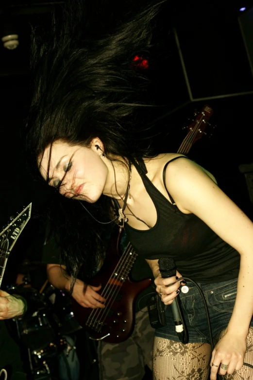 a girl with her head resting on her guitar