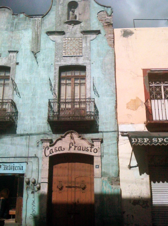 a old building with a wooden door in front