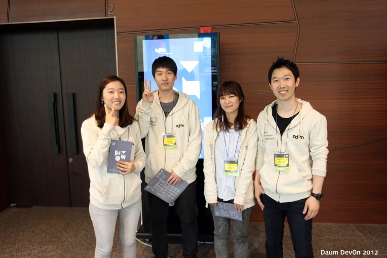 a group of people pose for a po holding books