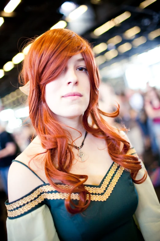 an orange haired woman with red hair and freckles looking off to the side