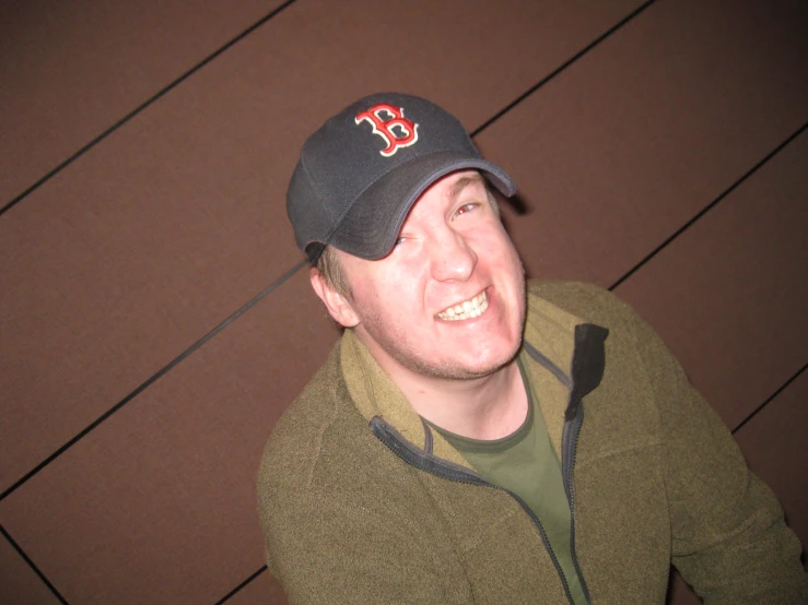 a man wearing a hat with the boston red sox on it