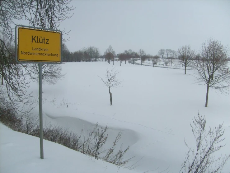 a large open field that is covered in snow