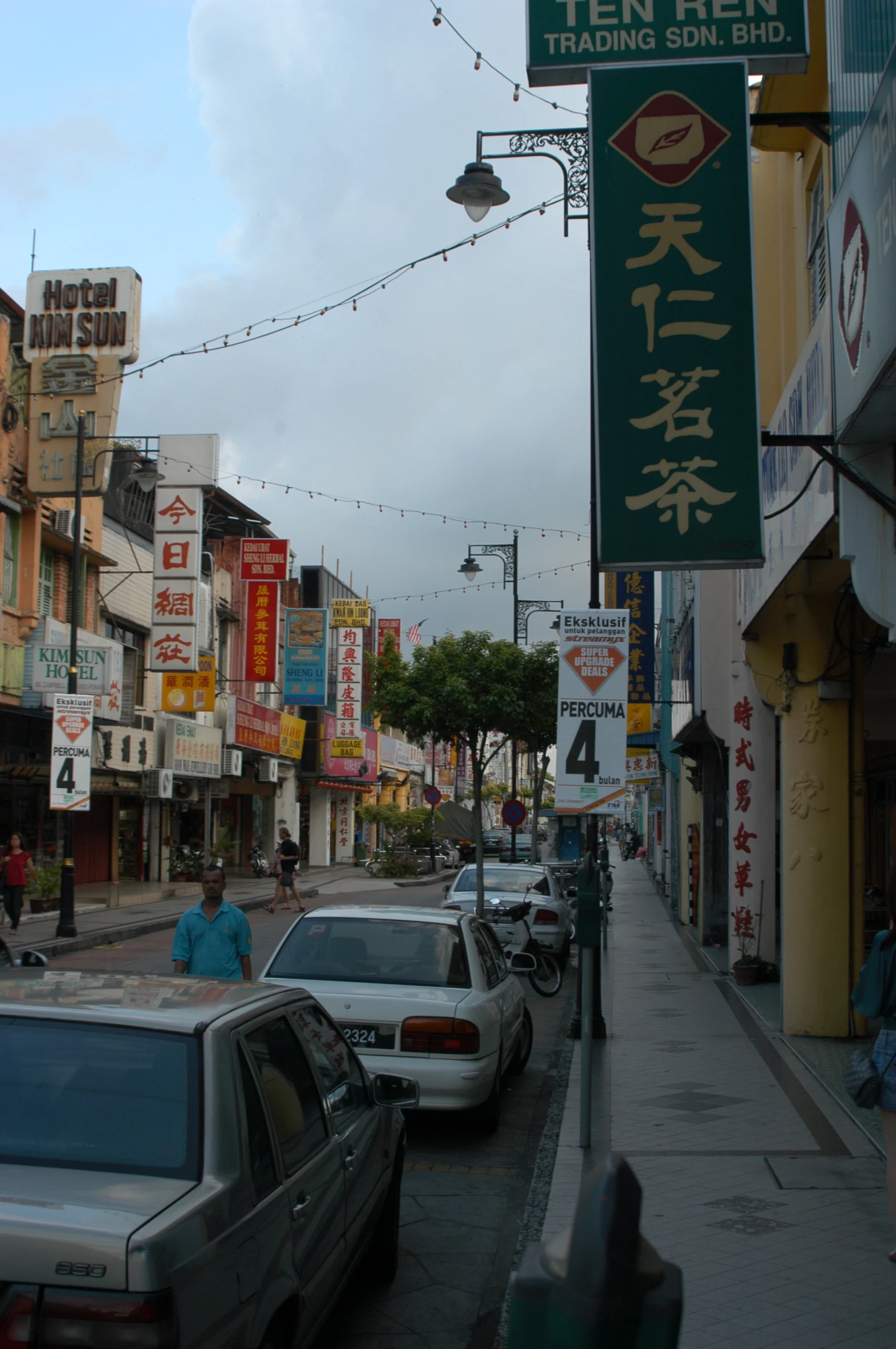 some cars parked along side of buildings in the city