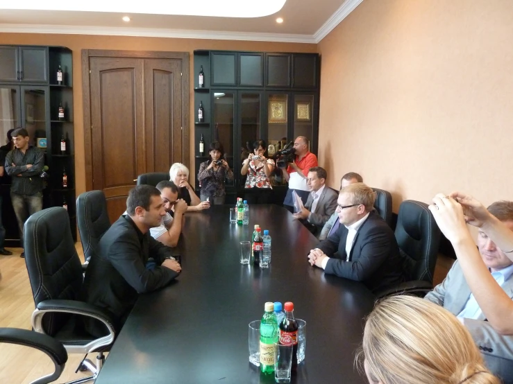 a group of people sitting around a conference table