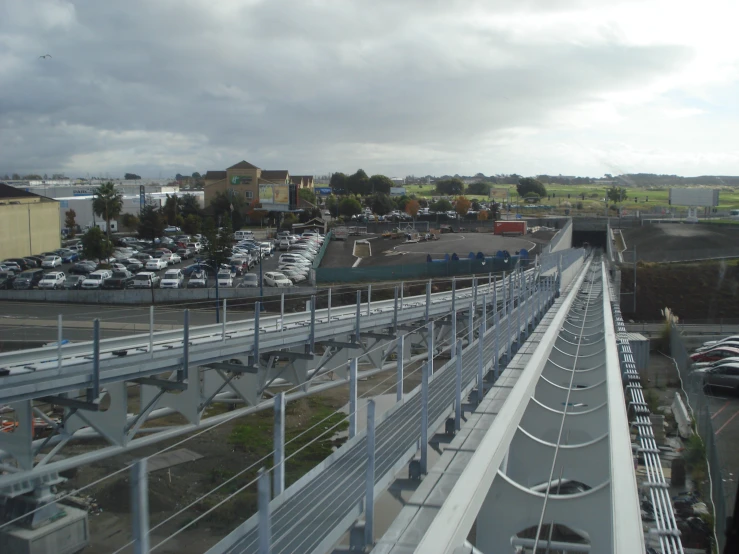 a large bridge with several tracks going over a parking lot