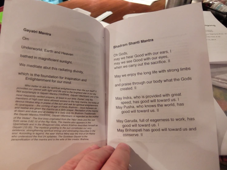 person holding open a book with an image on the page