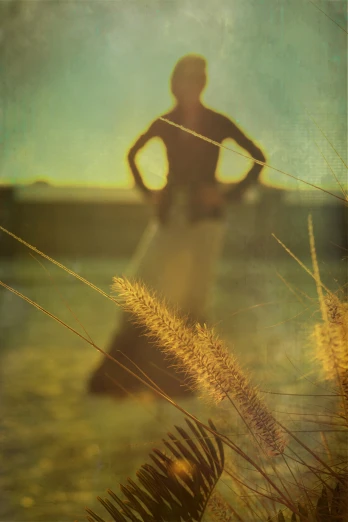 a person is standing in a field with grass