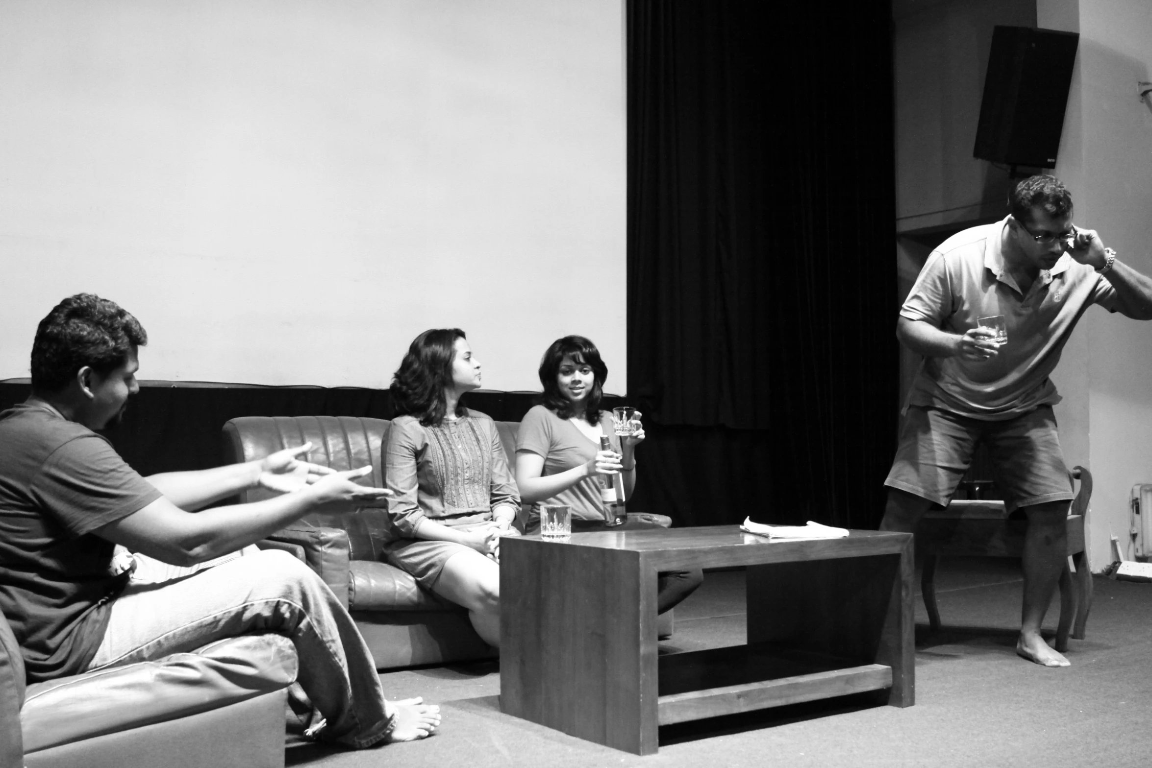 a black and white po of four people sitting on couches