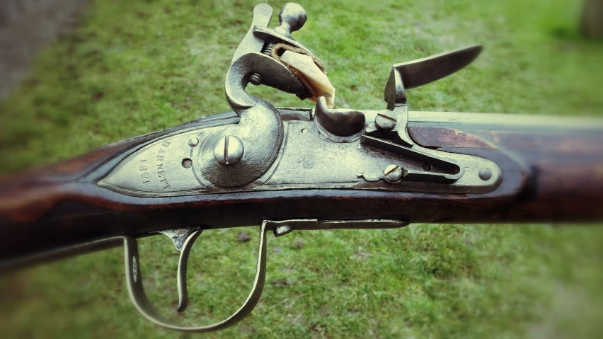 the side view of a winchester rifle with its trigger and other tools attached