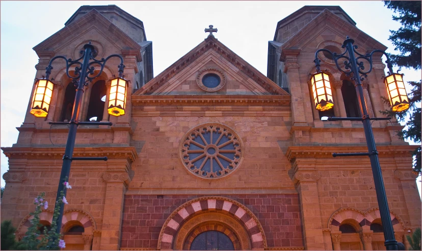 the lights on this building are gold and there is a clock