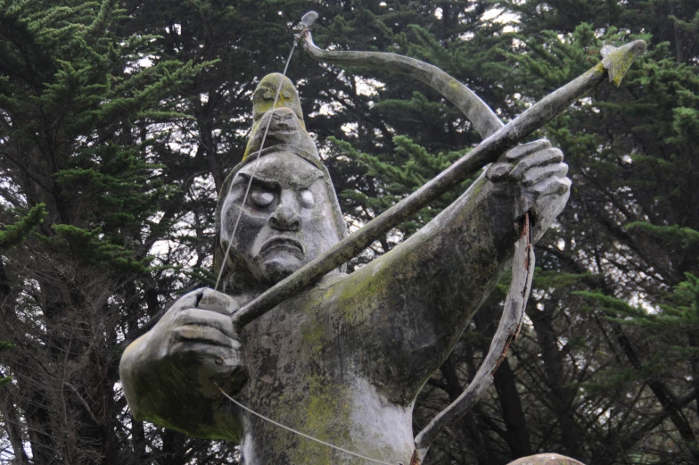 there is a statue that is holding an arrow