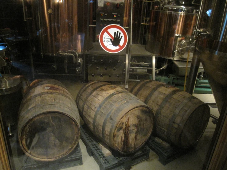 there are two barrels with hand prints in the reflection