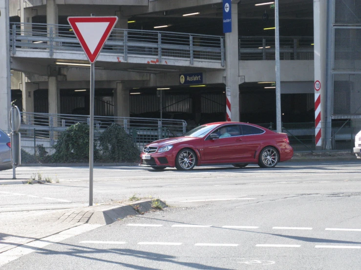 the car is parked at the corner of a building